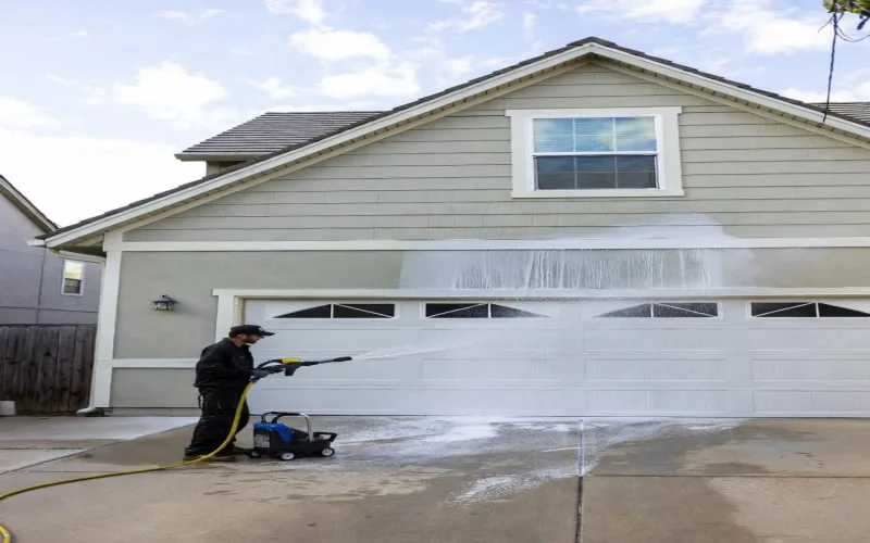 Garage and house exterior cleaned by professional pressure washing
